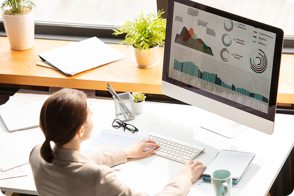 a woman reviewing her business's google reputation on a computer