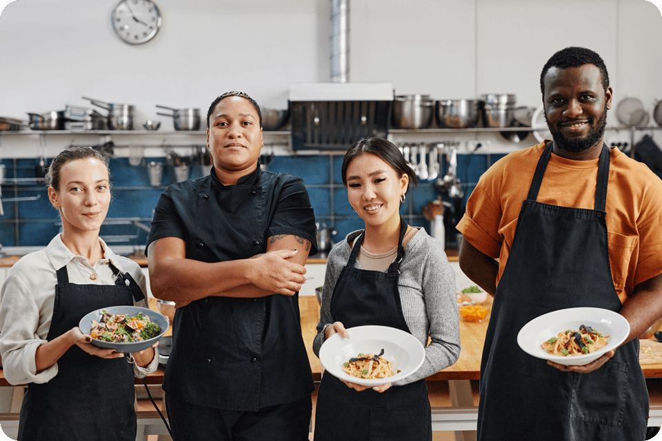 a restaurant staff showing off dishes